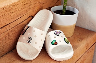 The Classic Crocs Slide in White, with Jibbitz™.